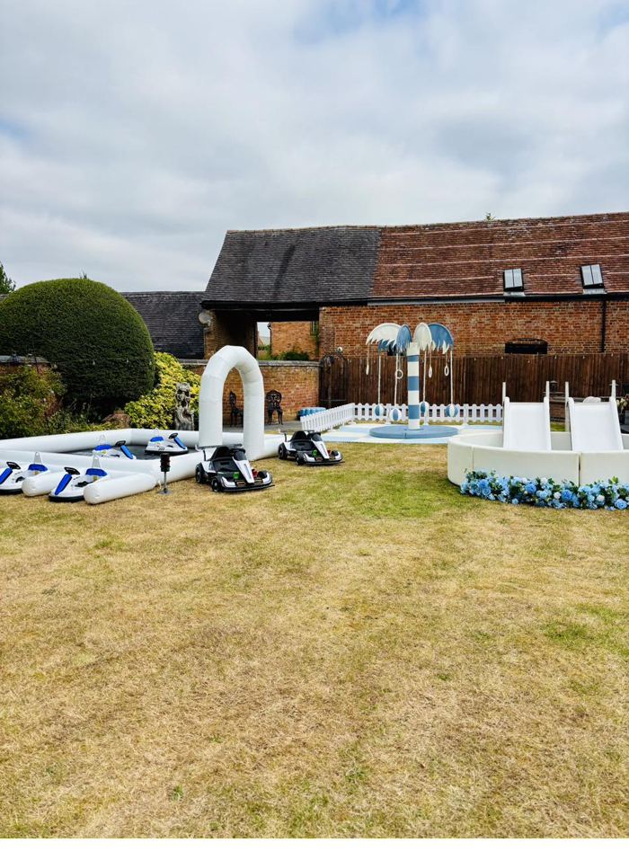 Blue garden party with electric cars, Carousel Tree and ball pit with slides and flowers