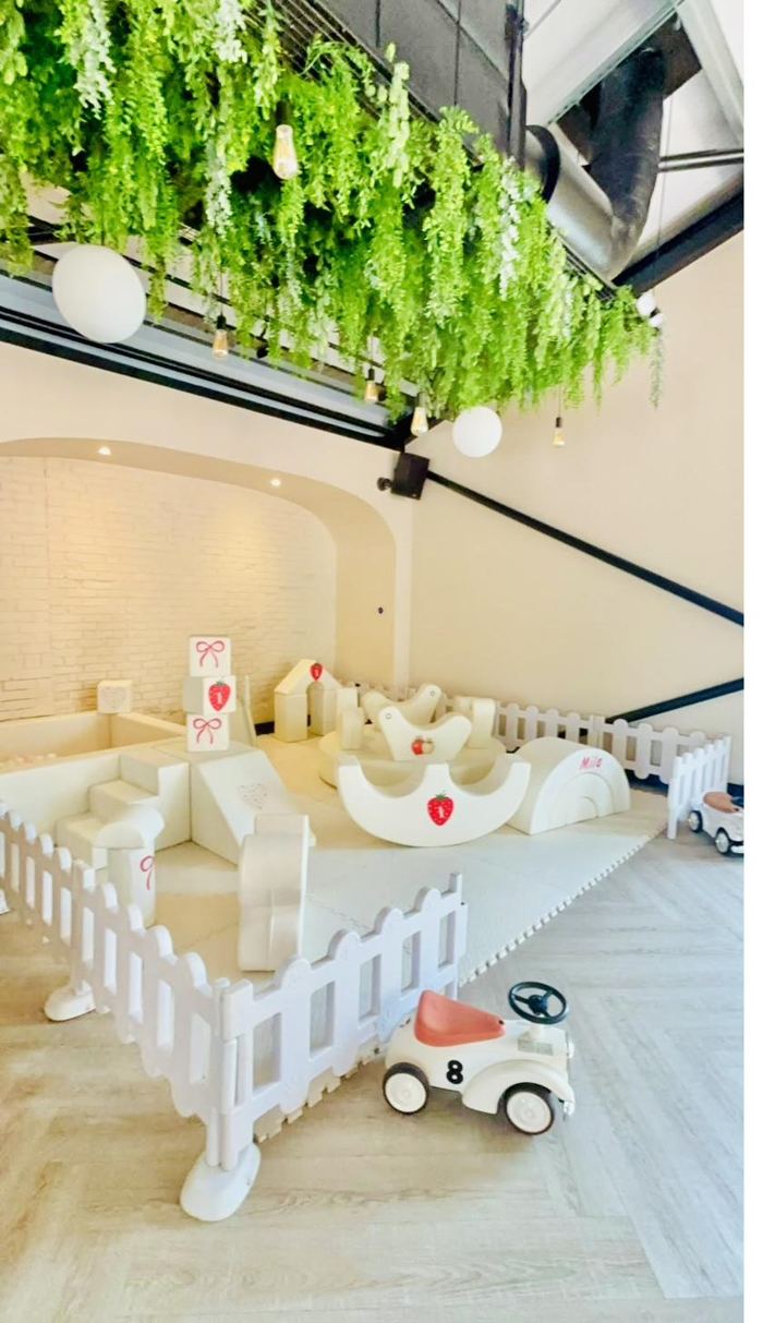 Cream soft play first birthday with strawberry personalisation, rockers and ride-on cars